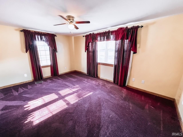 spare room featuring carpet floors, plenty of natural light, and ceiling fan