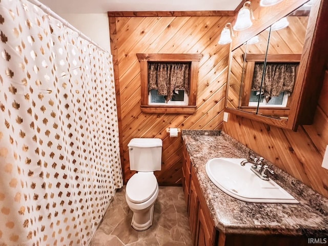 bathroom featuring wood walls, vanity, a shower with shower curtain, and toilet