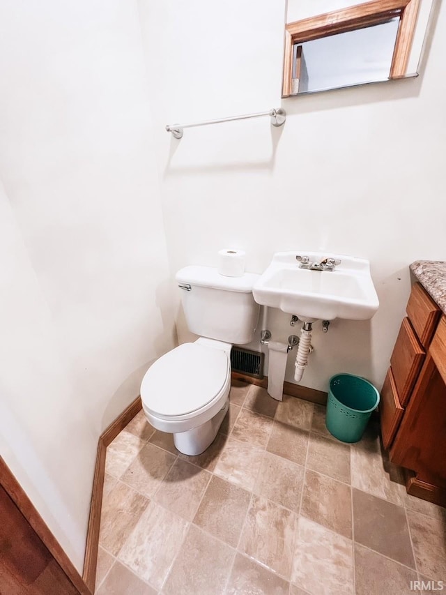 bathroom featuring toilet and sink