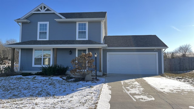 view of front of house with a garage, roof with shingles, driveway, and fence