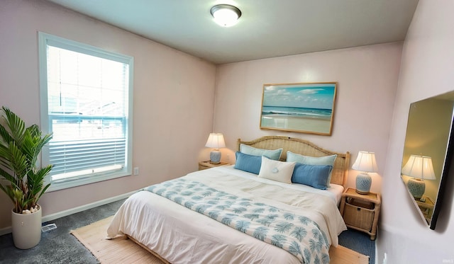 bedroom featuring dark carpet