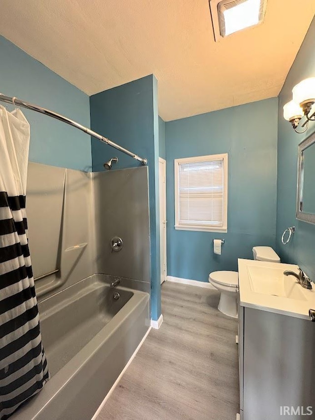 full bathroom featuring vanity, toilet, wood-type flooring, and shower / bath combo with shower curtain