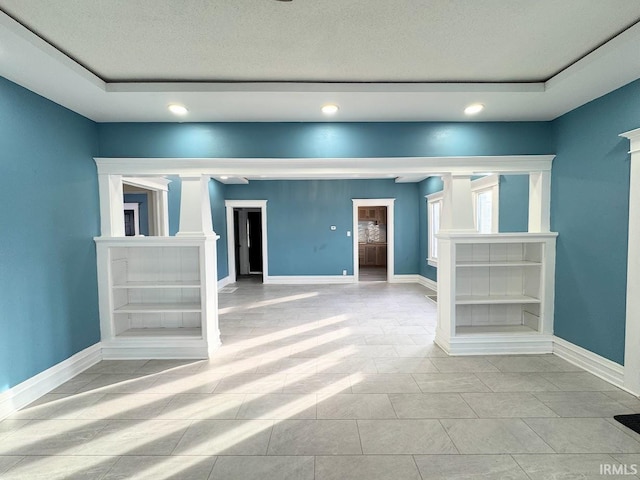 unfurnished room with a tray ceiling