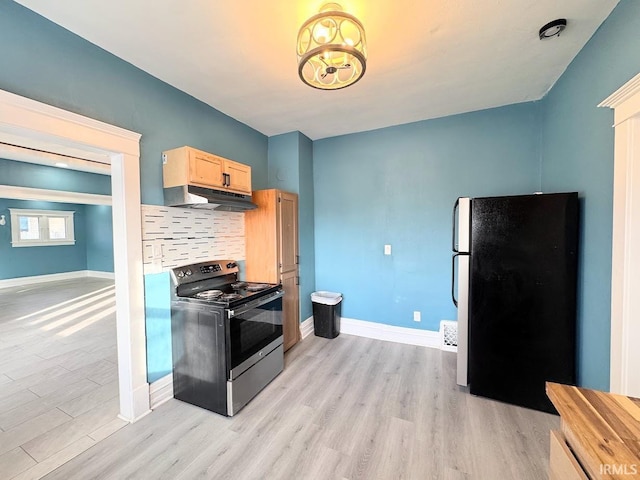 kitchen featuring black range oven, backsplash, refrigerator, light hardwood / wood-style floors, and light brown cabinetry