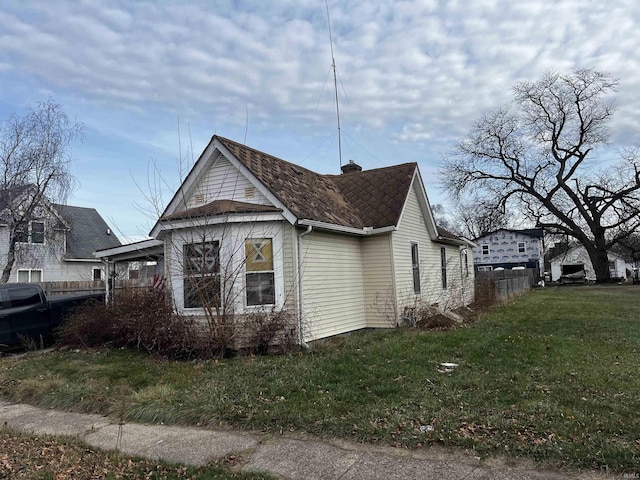 view of side of home featuring a yard