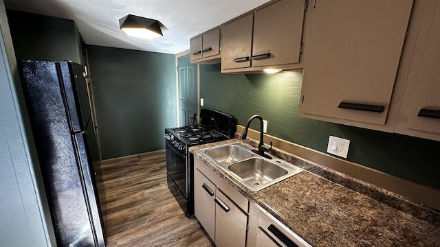 kitchen featuring hardwood / wood-style floors, sink, and black appliances