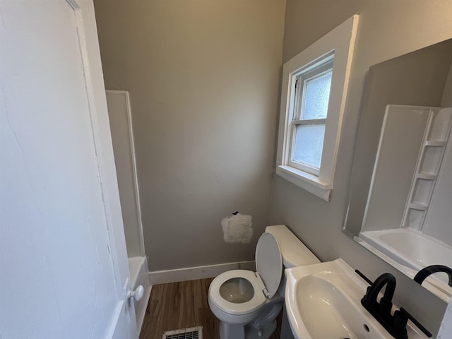 bathroom featuring hardwood / wood-style flooring, toilet, and sink