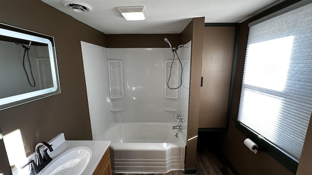 bathroom featuring bathing tub / shower combination, vanity, and wood-type flooring