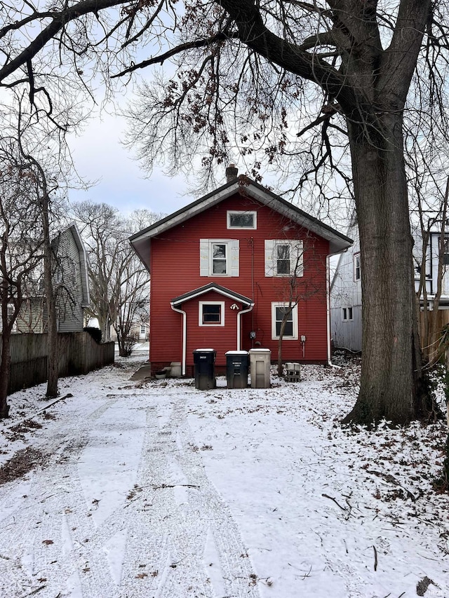 view of snow covered back of property