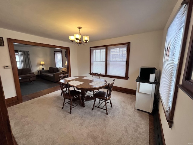 dining space featuring a notable chandelier