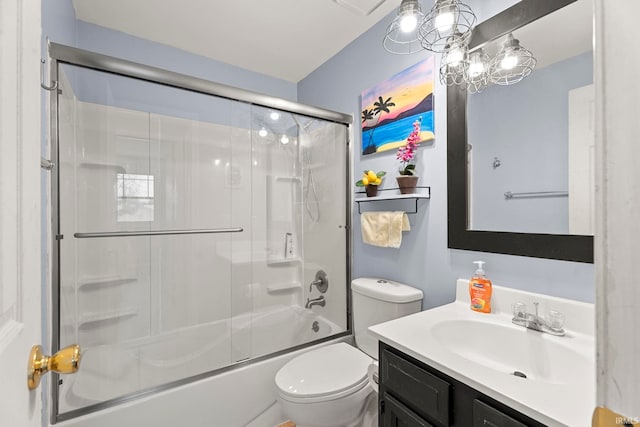 full bathroom featuring vanity, toilet, and shower / bath combination with glass door