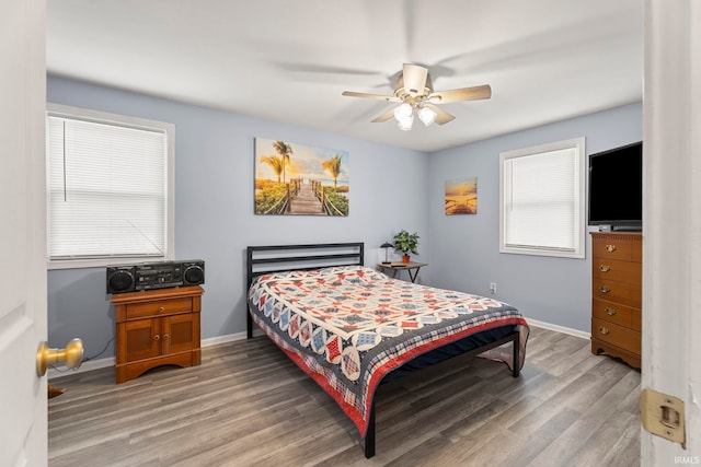 bedroom with wood-type flooring and ceiling fan