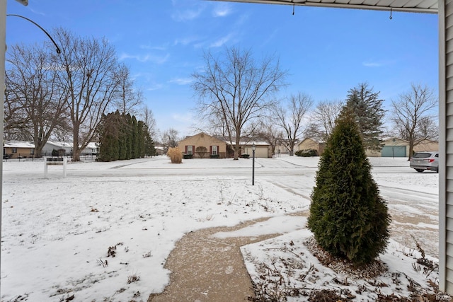 view of yard layered in snow