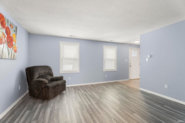 sitting room featuring a textured ceiling and hardwood / wood-style flooring