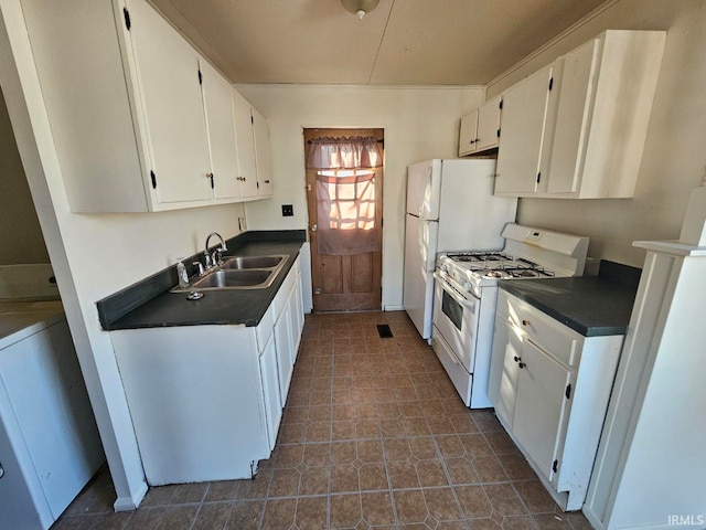 kitchen featuring white cabinetry, gas range gas stove, and sink