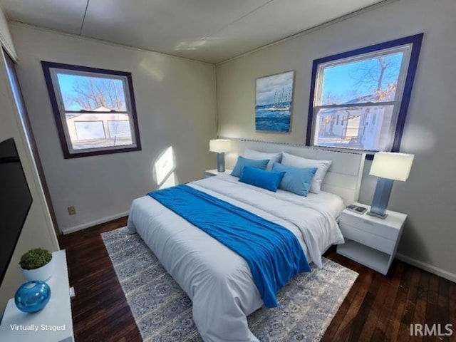 bedroom with dark hardwood / wood-style flooring