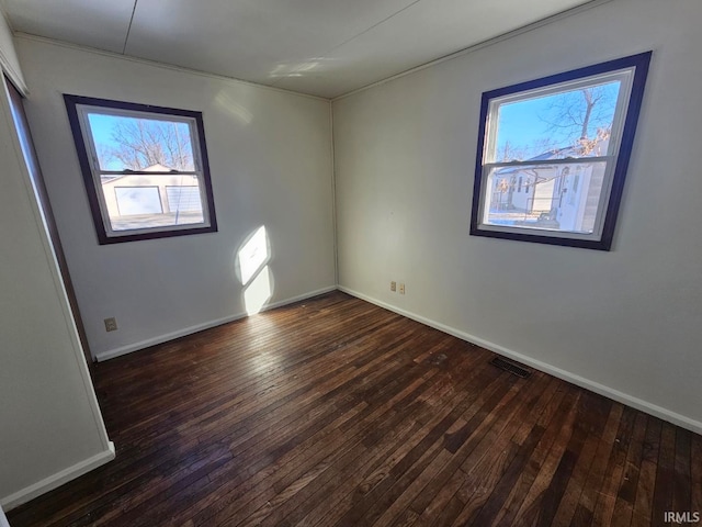 spare room featuring dark hardwood / wood-style floors