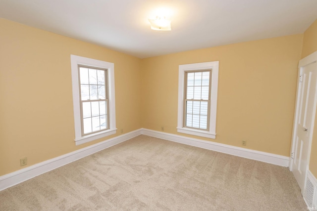 carpeted empty room featuring plenty of natural light