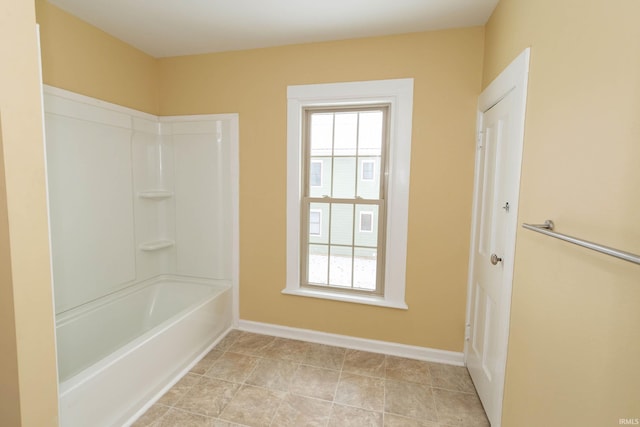 bathroom with plenty of natural light and washtub / shower combination