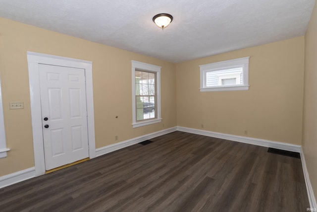 spare room with dark wood-type flooring