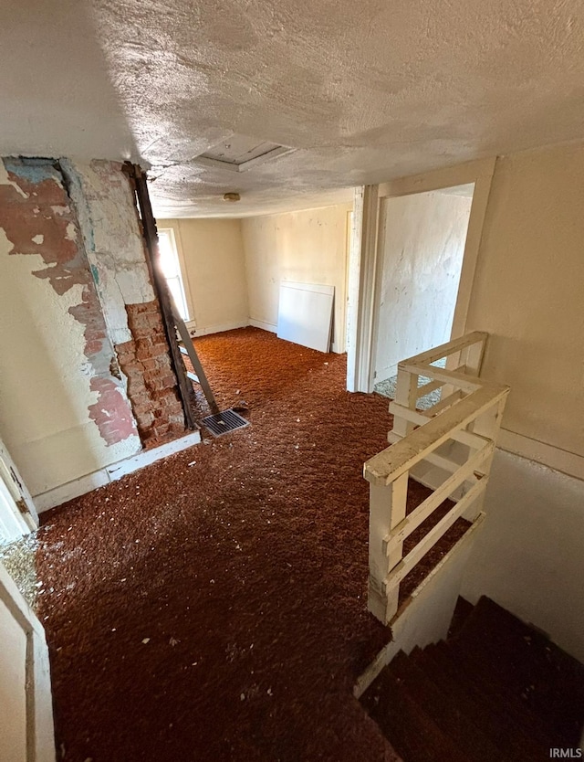 miscellaneous room with a textured ceiling