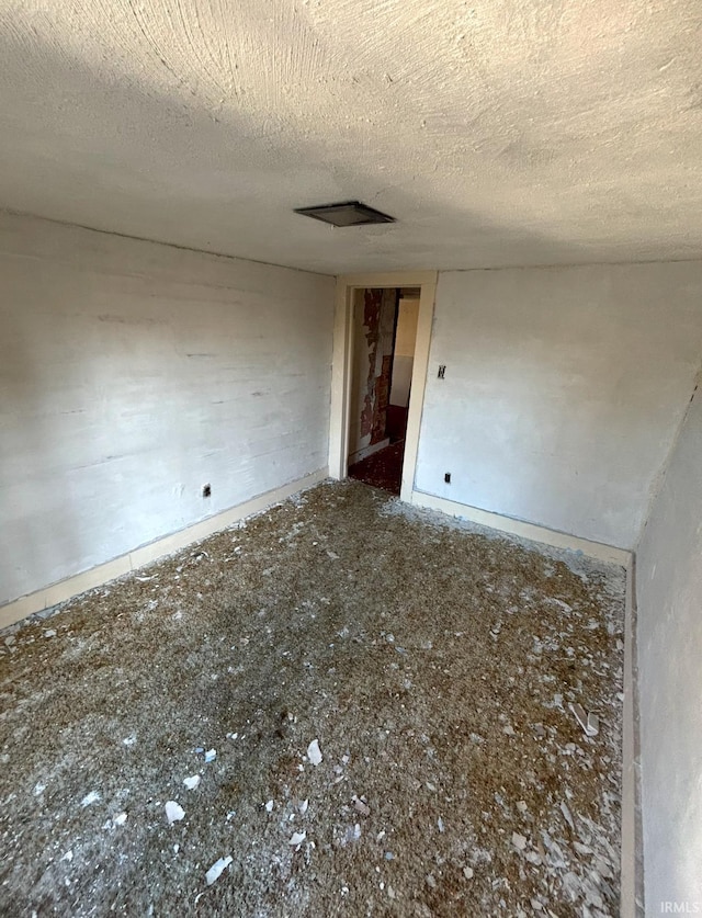 spare room with a textured ceiling