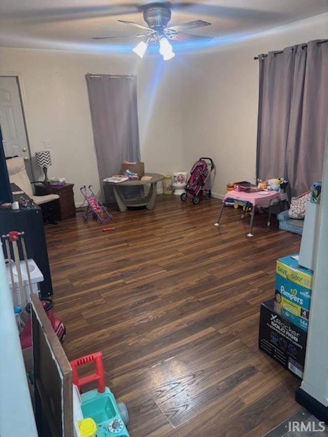 game room with dark hardwood / wood-style flooring and ceiling fan