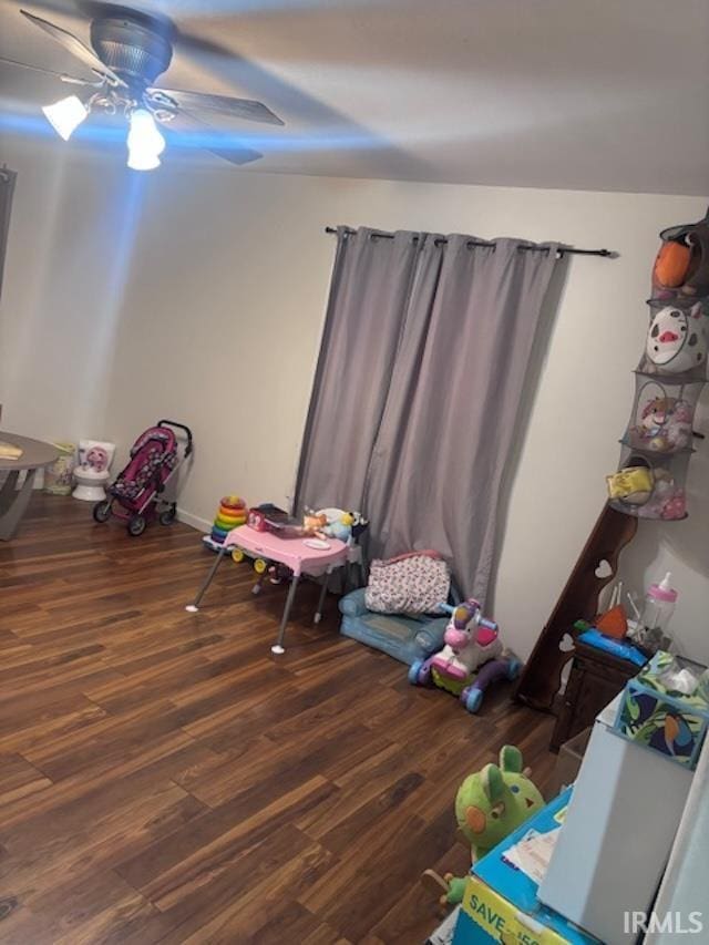 recreation room with dark hardwood / wood-style floors and ceiling fan