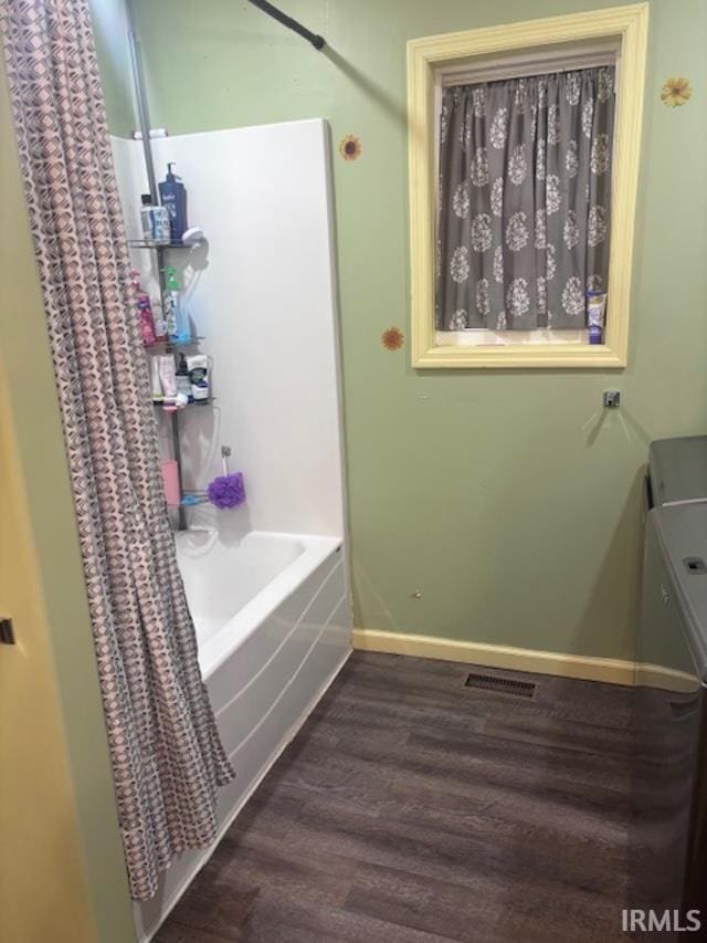 bathroom featuring hardwood / wood-style flooring and shower / bathing tub combination