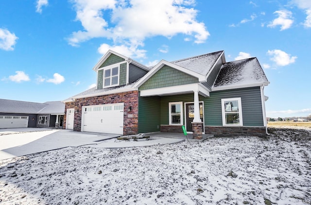 craftsman-style house featuring covered porch and a garage