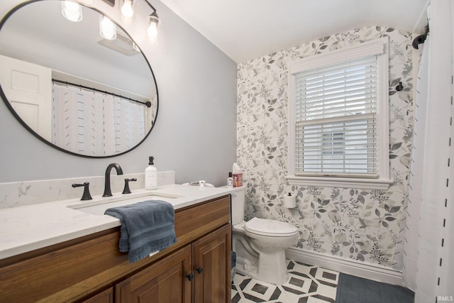 bathroom featuring vanity and toilet