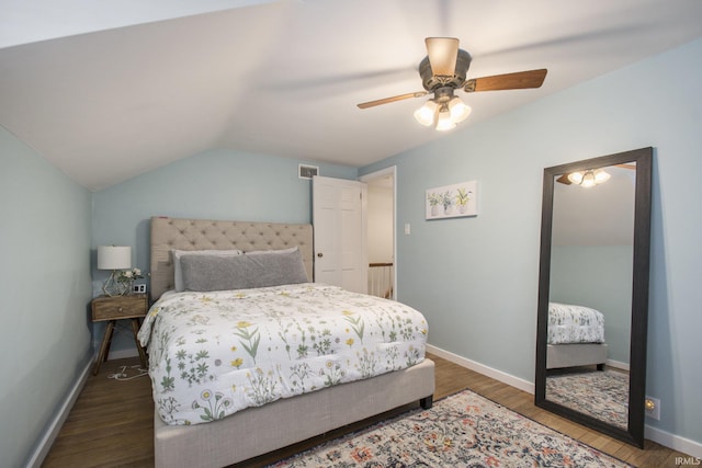 bedroom with vaulted ceiling, ceiling fan, and dark wood-type flooring