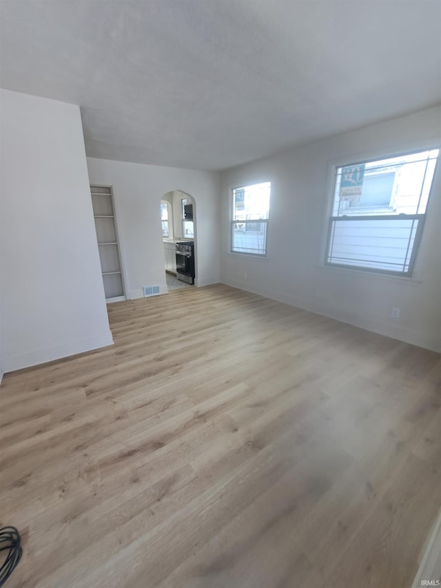 unfurnished living room with light hardwood / wood-style flooring