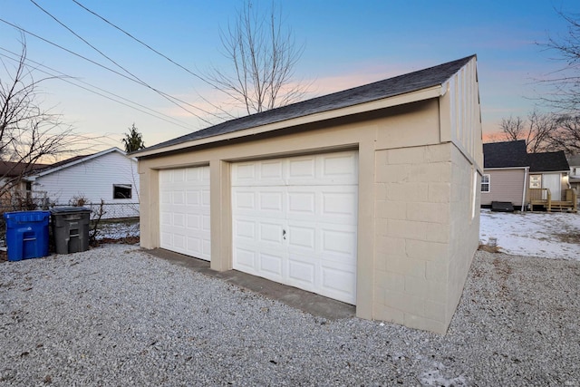 view of garage at dusk