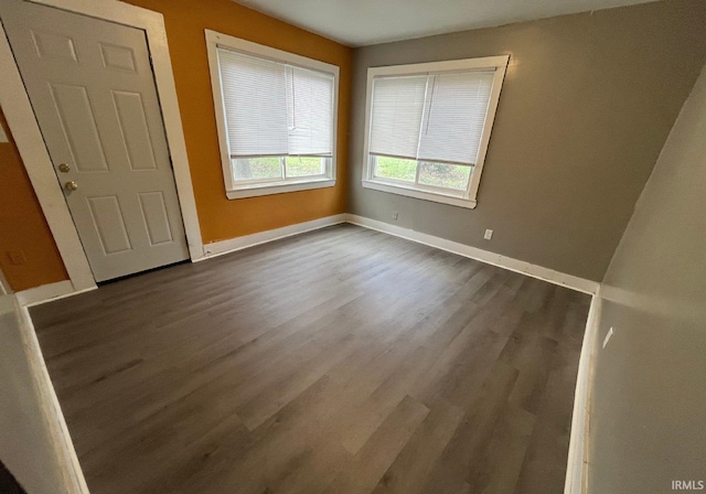 spare room with dark wood-type flooring