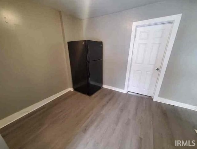 empty room with wood-type flooring