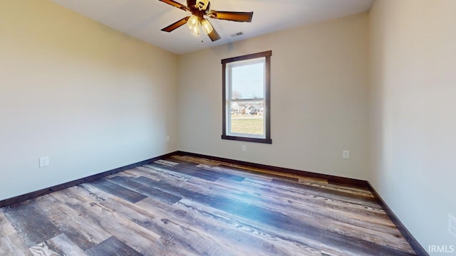 empty room featuring visible vents, ceiling fan, baseboards, and wood finished floors