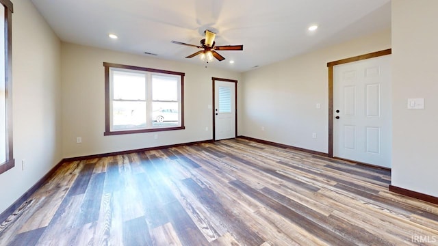 spare room featuring visible vents, a ceiling fan, wood finished floors, recessed lighting, and baseboards