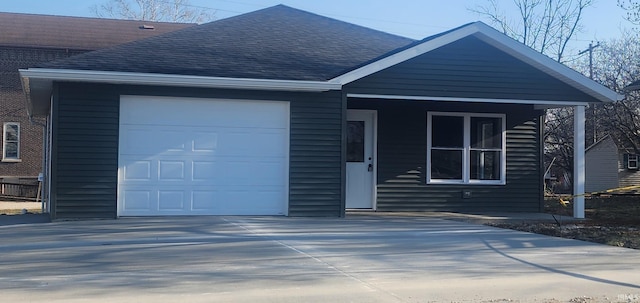 ranch-style house featuring a garage, concrete driveway, and a shingled roof