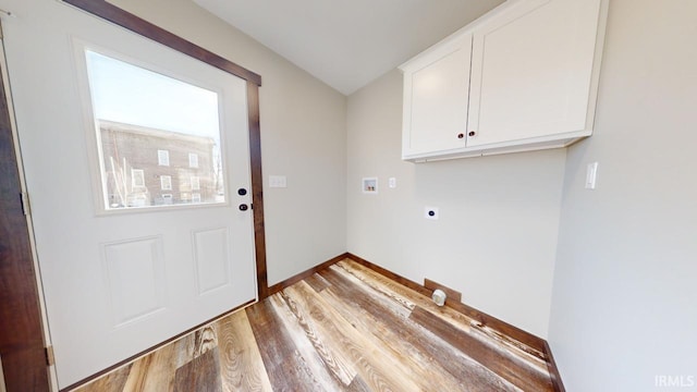 washroom featuring baseboards, hookup for a washing machine, wood finished floors, cabinet space, and electric dryer hookup