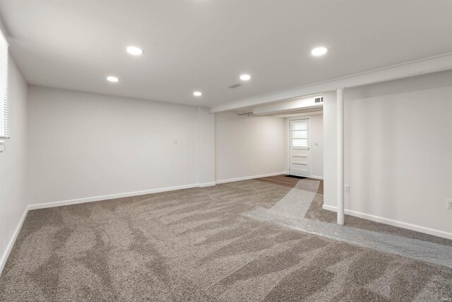 empty room featuring dark carpet and crown molding