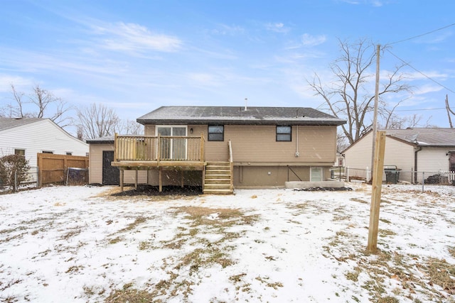 snow covered property featuring a wooden deck