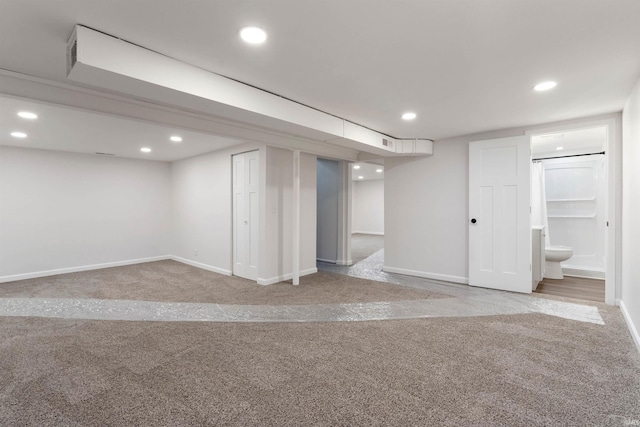 basement featuring light carpet