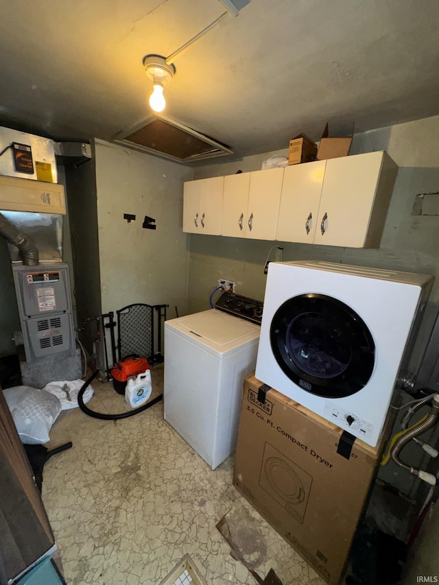 laundry room featuring cabinets and washing machine and dryer