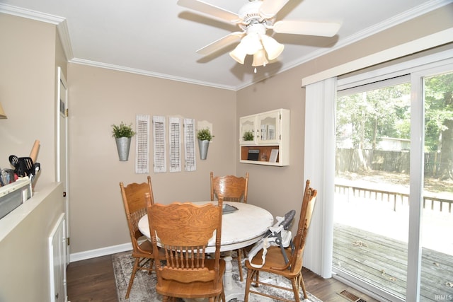 dining room with dark hardwood / wood-style flooring, ceiling fan, and ornamental molding