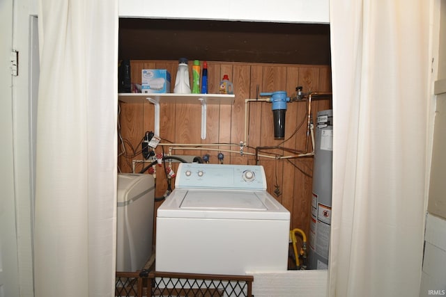 laundry room with independent washer and dryer and water heater