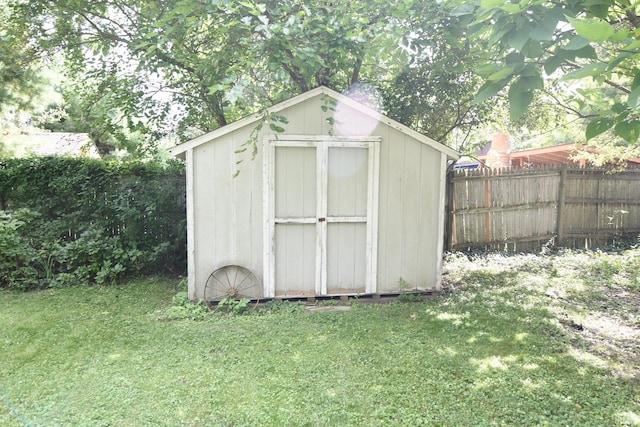 view of outbuilding featuring a lawn