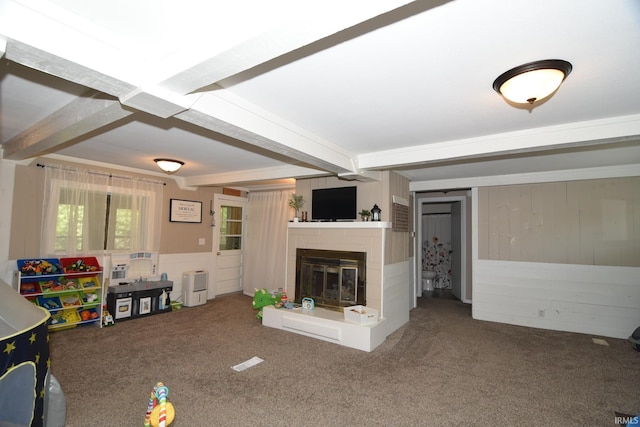 unfurnished living room featuring beam ceiling and carpet floors