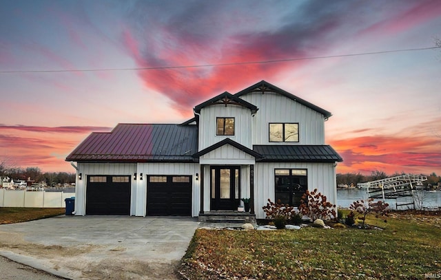 modern farmhouse style home with a yard and a water view