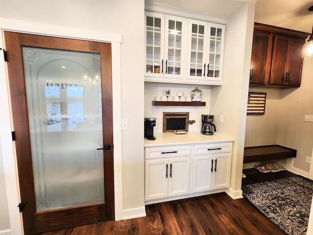 bar with white cabinets and dark wood-type flooring